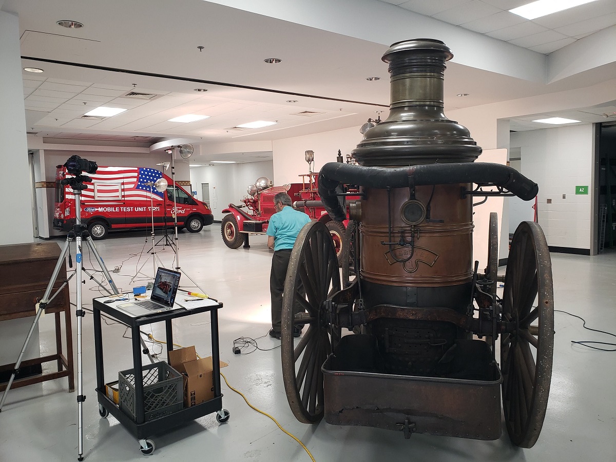 Photographing the Ford COVID-19 mobile testing van Man works at photographic equipment among several vehicles in a large room