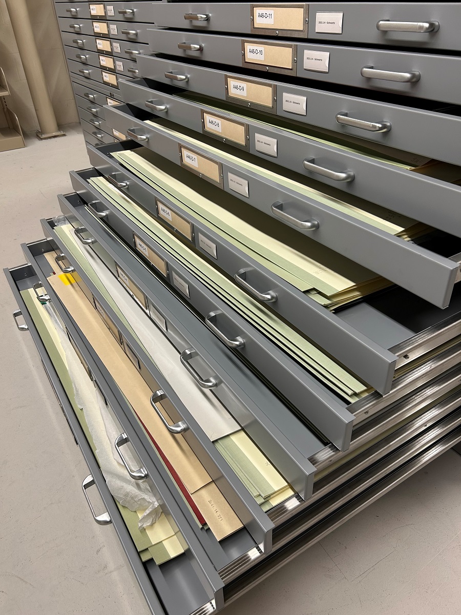 Flat files containing Lillian Schwartz material in the archives at The Henry Ford Large flat filing cabinet opened in a waterfall fashion to show flat folders and papers inside