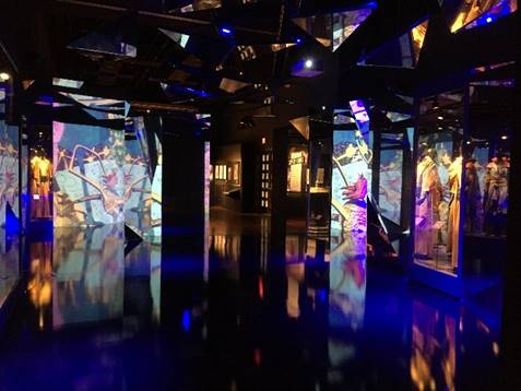 Dark room with illuminated images at various angles