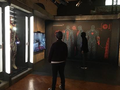 Person looking toward intersection of two walls with images and text