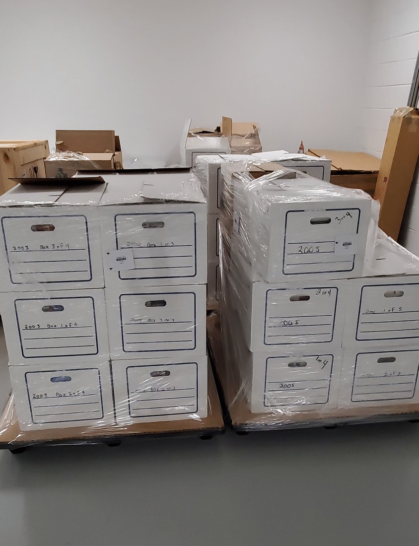 GIF showing two views of cardboard boxes shrinkwrapped onto pallets