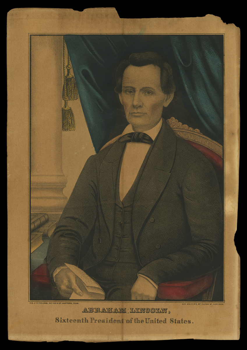 Man in suit sits in chair in front of blue curtain; also contains text