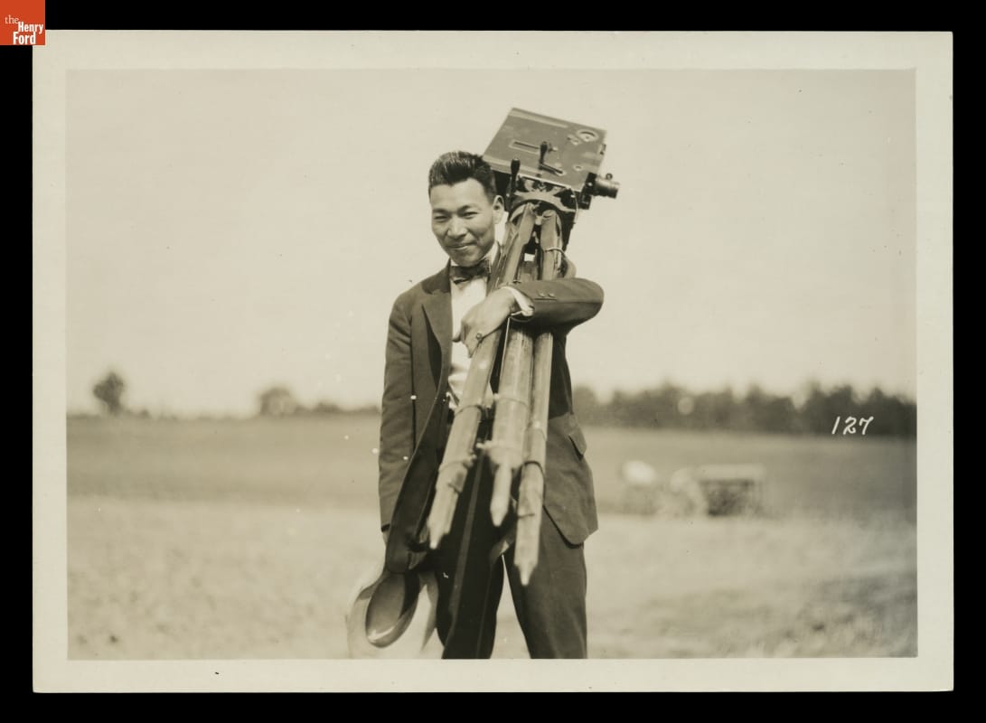 Tsuneji “Thomas” Sato carrying a camera on a 1918 camping trip.