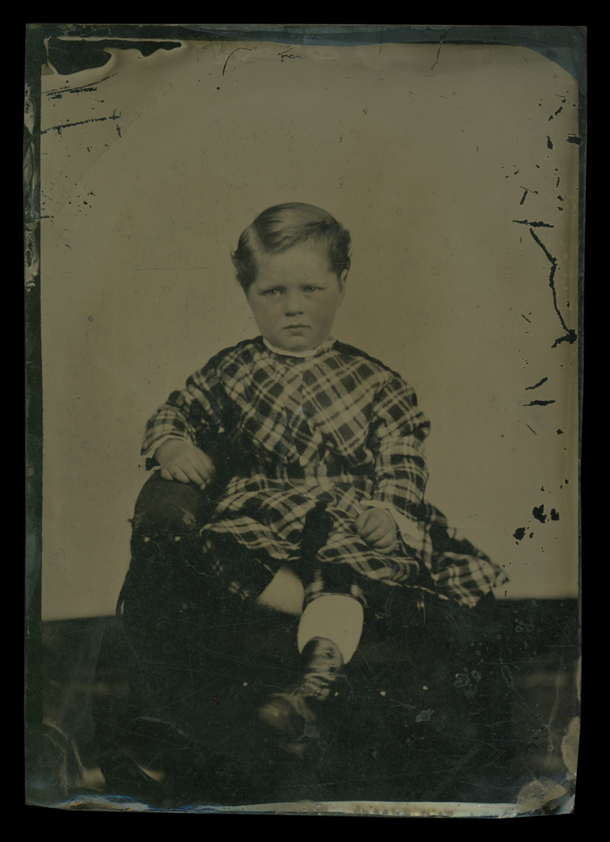 Young Boy in a Plaid Dress with Pantaloons, 1860-1870 Sitting child in plaid dress