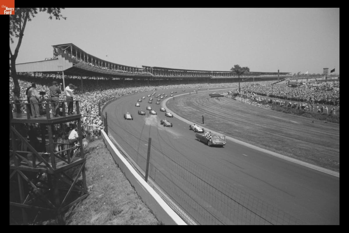Ford Thunderbird, Official Pace Car at Indianapolis 500, May 30, 1961 Black-and-white photo of many cars on race track, with grandstands full of fans on both sides of the track
