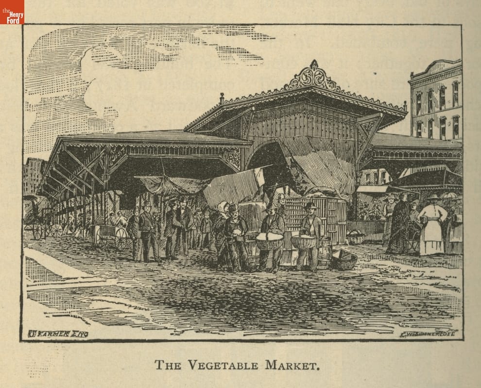 Large, open-sided building with many stands and people around it