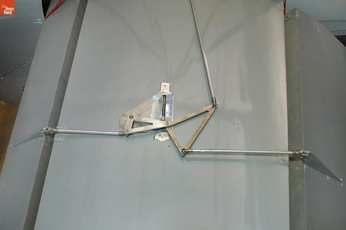 1920 Dayton-Wright RB-1 Monoplane / steering mechanism detail Close-up of gray plane wing with triangular metal pieces attached to long rods