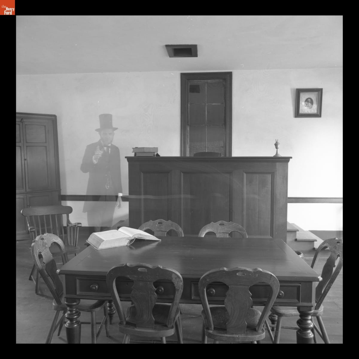 "Ghost of Abraham Lincoln" in Logan County Courthouse for Halloween in Greenfield Village, 1982 Transparent figure of Abraham Lincoln standing in room with table and dais