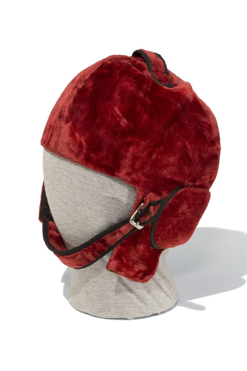 Helmet Used by George Robertson in 1908 Vanderbilt Cup Race Brick-red velvet helmet with chin strap and ear flaps on mannequin head