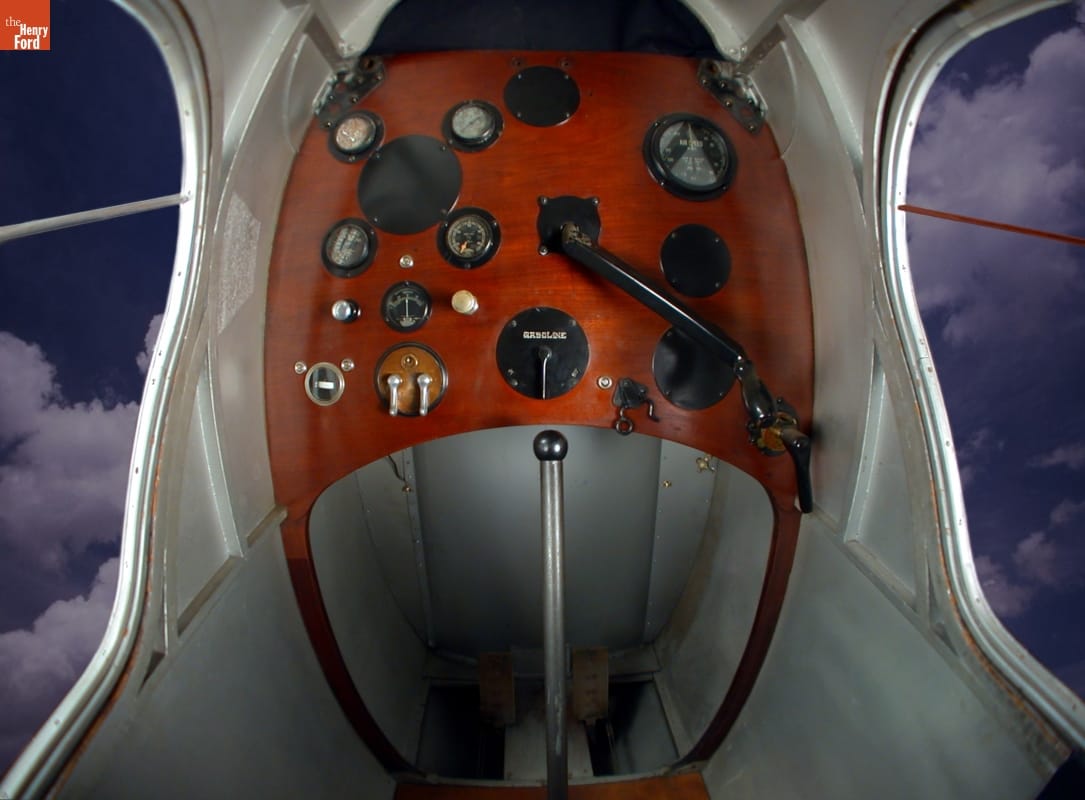 1920 Dayton-Wright RB-1 Monoplane / cockpit Plane cockpit with large wooden panel of instruments and gauges above legroom with pedals; no windows in front but large windows to the left and right