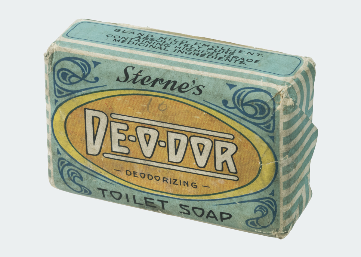 Bar of soap wrapped in blue paper with decorative blue elements and yellow-orange oval and text