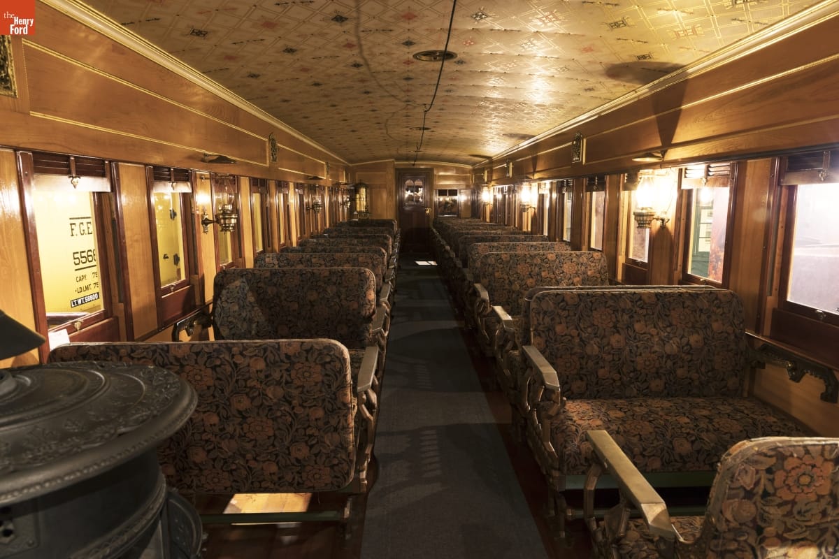 Bangor & Aroostook Railroad Passenger Coach Replica Interior of train car with wooden walls and ceiling and floral upholstered bench seats