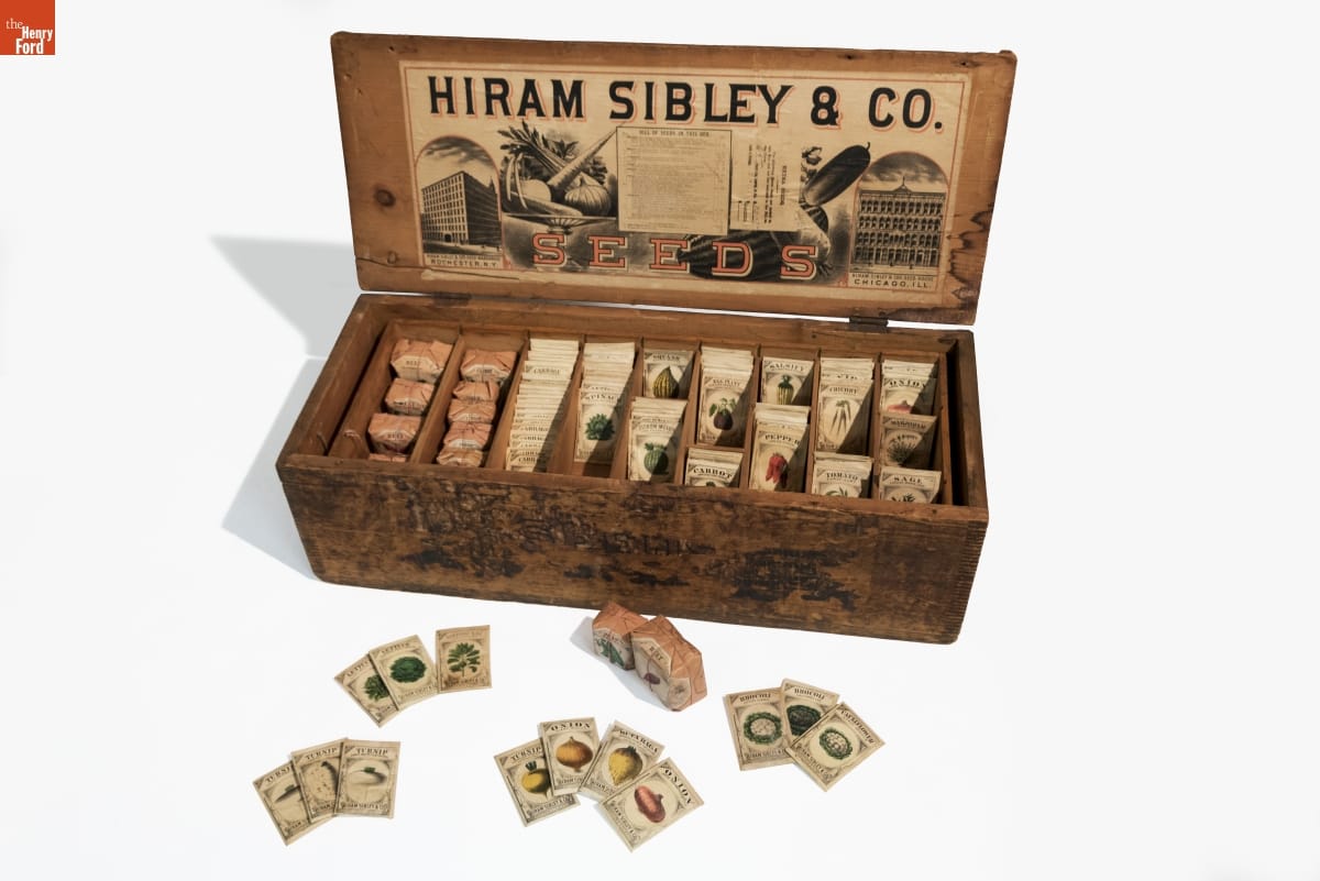 Hiram Sibley & Co. Seed Box, Used in the C.W. Barnes Store, 1882-1888 Wooden box with lid flipped back, text and images inside lid, packets inside box and some outside box