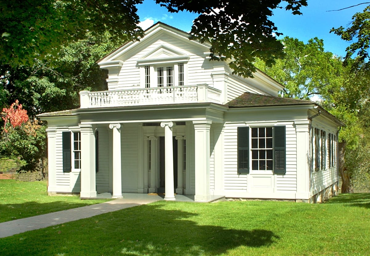 Robert Frost Home White, two-story wooden house with porch with columns