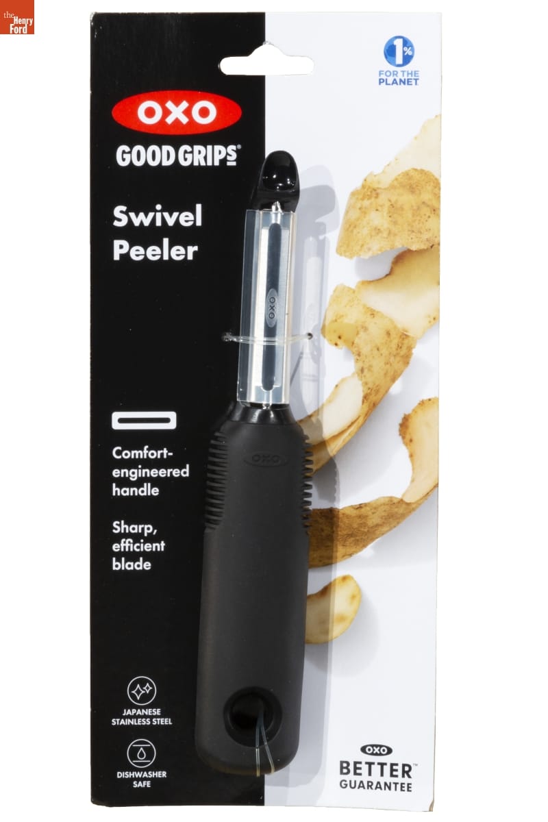 OXO Good Grips Swivel Peeler, 2022 Vegetable peeler with broad black handle in black and white plastic blisterpack with text and image of potato peelings