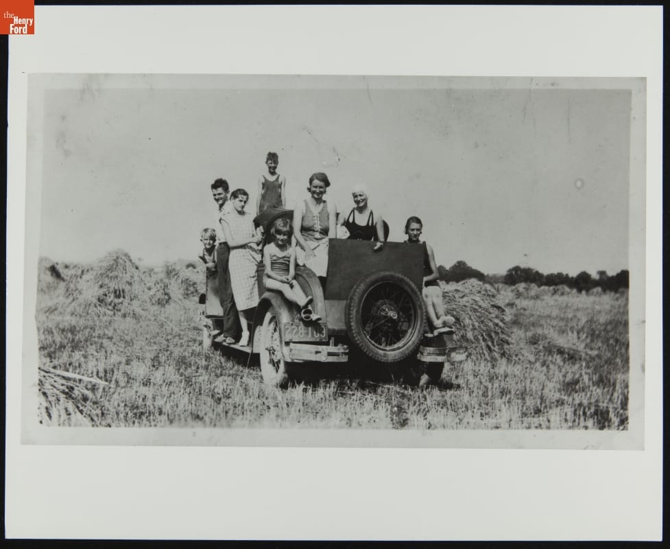Group of about seven people in and on a truck