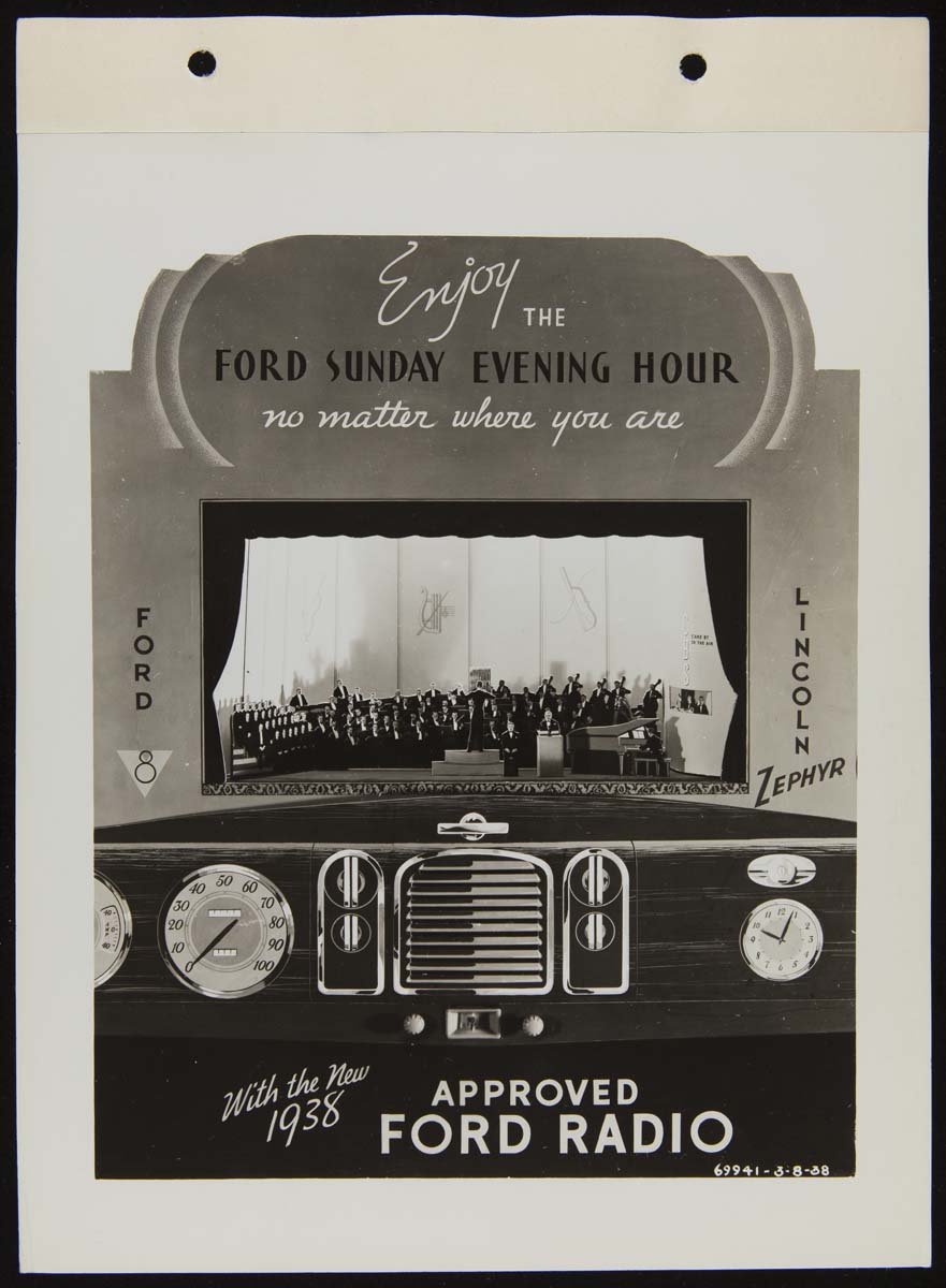 Display with image of orchestra on stage above a car dashboard, including radio; also contains text
