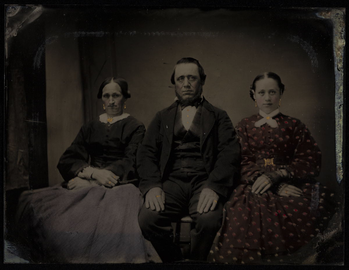 Family of Seven Portrait with Gold Accents, 1860-1869 Two women sitting on either side of a seated man