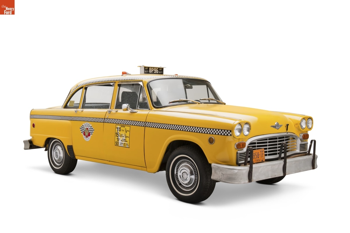 1981 Checker Marathon Taxicab Yellow taxi with signage on top and sides of car and black-and-white checked strip along full side of car