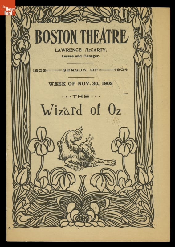 Program cover with text, image of lion, floral border